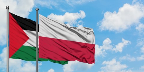 Palestine and Poland flag waving in the wind against white cloudy blue sky together. Diplomacy concept, international relations.