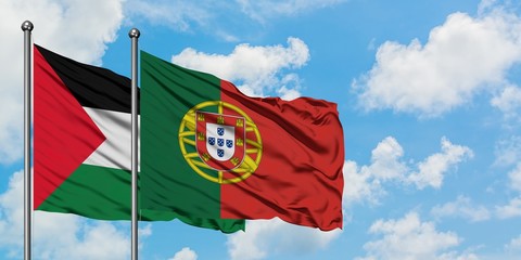 Palestine and Portugal flag waving in the wind against white cloudy blue sky together. Diplomacy...