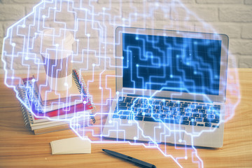 Double exposure of table with computer and brain hologram. Data innovation concept.