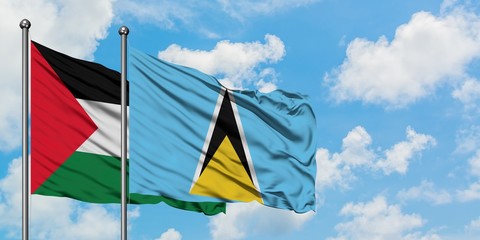 Palestine and Saint Lucia flag waving in the wind against white cloudy blue sky together. Diplomacy concept, international relations.