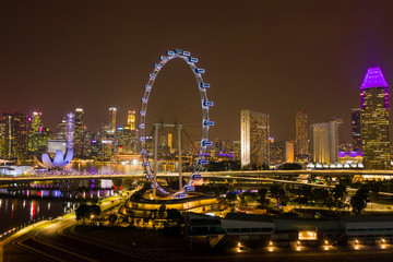 Aerial view of Singapore Flyer Giant Ferris Wheel and Helix Bridge with City Skyline illuminated at...