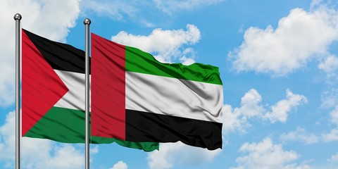 Palestine and United Arab Emirates flag waving in the wind against white cloudy blue sky together. Diplomacy concept, international relations.