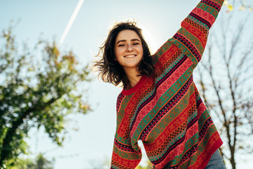 Bottom view image of happy beautiful young woman smiling broadly with windy hair and freckles has...