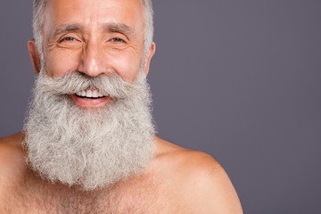 Close up cropped photo of cheerful positive well old man smiling toothily with teeth repaired just...