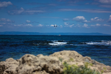 Parachute in the sky over the sea, waves, sunny day and holidays