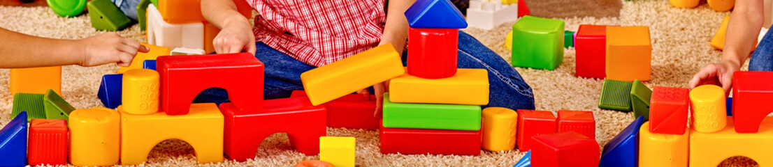 Baby cubes on horizontal long strip, banner design. Body part children hands playing in preschool.