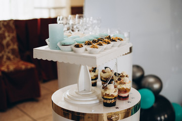 Candy bar in mint color. Delicious sweets on candy buffet. Lot of colorful desserts on table. Selective focus