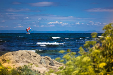 Parachute in the sky over the sea, waves, sunny day and holidays