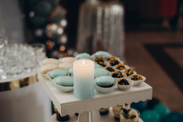 Candy bar in mint color. Delicious sweets on candy buffet. Lot of colorful desserts on table. Selective focus