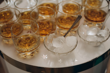 whiskey with ice in glass glasses