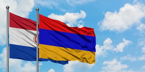 Paraguay and Armenia flag waving in the wind against white cloudy blue sky together. Diplomacy concept, international relations.