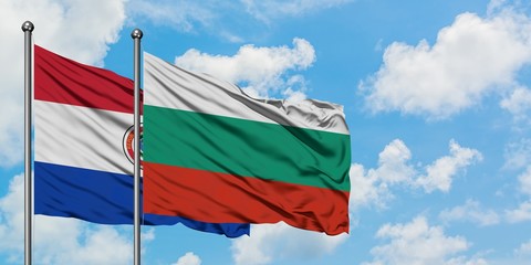 Paraguay and Bulgaria flag waving in the wind against white cloudy blue sky together. Diplomacy concept, international relations.