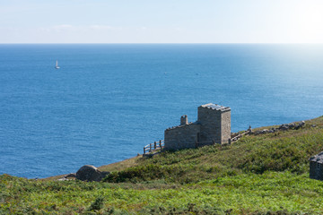 Fototapeta na wymiar stone house on cliff next to the ocean