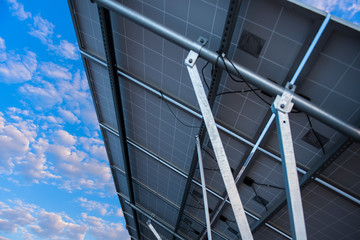 Solar panel, photovoltaic and alternative power supply in the background of blue sky and white clouds -- the concept of sustainable resources