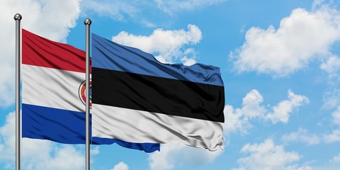 Paraguay and Estonia flag waving in the wind against white cloudy blue sky together. Diplomacy concept, international relations.