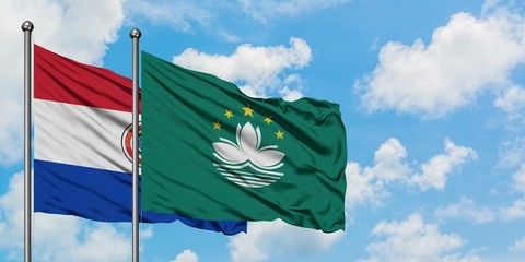 Paraguay and Macao flag waving in the wind against white cloudy blue sky together. Diplomacy concept, international relations.