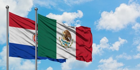 Paraguay and Mexico flag waving in the wind against white cloudy blue sky together. Diplomacy concept, international relations.