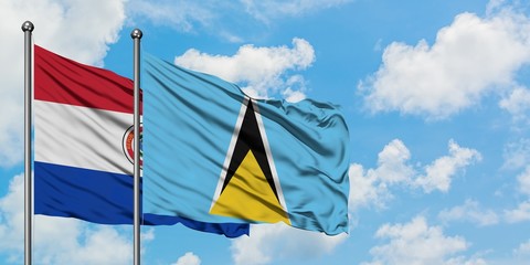 Paraguay and Saint Lucia flag waving in the wind against white cloudy blue sky together. Diplomacy concept, international relations.