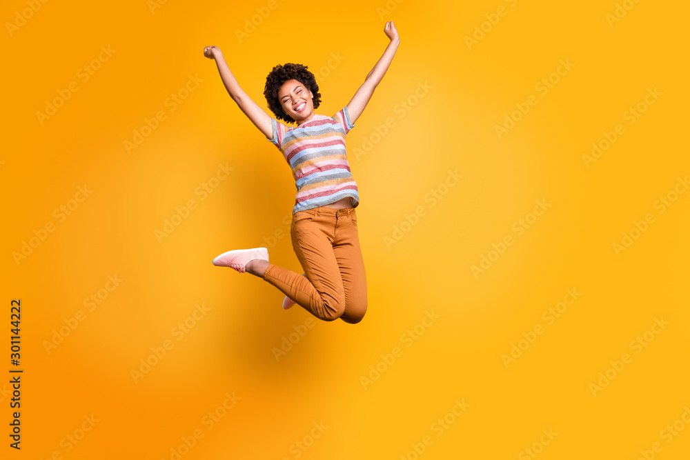 Canvas Prints Full length body size photo of cheerful rejoicing curly wavy casual beautiful youngster ecstatic about buying new orange trousers striped t-shirt isolated bright color background