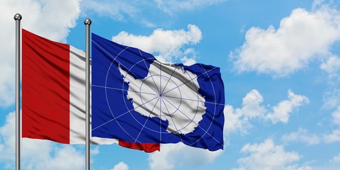Peru and Antarctica flag waving in the wind against white cloudy blue sky together. Diplomacy...