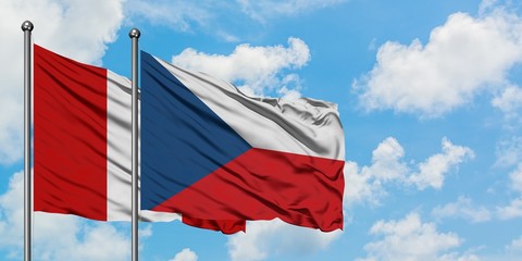 Peru and Czech Republic flag waving in the wind against white cloudy blue sky together. Diplomacy concept, international relations.