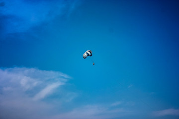 Parachute in the sky over the sea in summer.