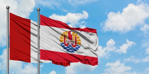 Peru and French Polynesia flag waving in the wind against white cloudy blue sky together. Diplomacy...
