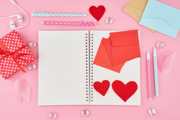 BlanThe concept of writing note, letters for Valentine's Day. Notepad page in bullet journal on bright pink office desktop. Top view of modern table with notebook. Mock up, copy space