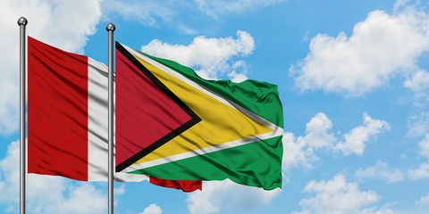 Peru and Guyana flag waving in the wind against white cloudy blue sky together. Diplomacy concept,...