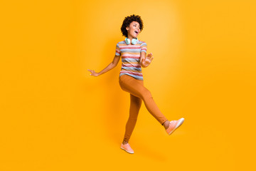 Fototapeta na wymiar Full body photo of positive cheerful crazy brown hair girl have headset listen radio melody song music dance feel content expression wear casual style outfit isolated yellow color background