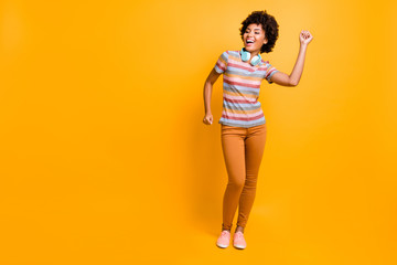 Fototapeta na wymiar Full length photo of cheerful girl have headset listen stereo music song dance feel rejoice emotions wear casual style outfit isolated over bright color background