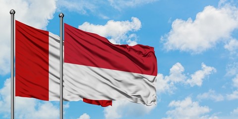 Peru and Monaco flag waving in the wind against white cloudy blue sky together. Diplomacy concept,...