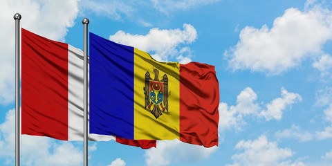 Peru and Moldova flag waving in the wind against white cloudy blue sky together. Diplomacy concept, international relations.