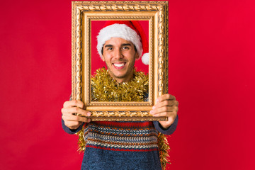 Fototapeta premium Young man holding a gift on christmas day