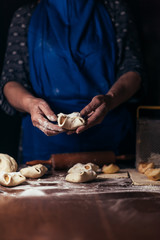 Pie on dark with hand. concept of decorating bakery. Pie making concept.