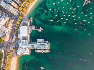 Vertical bird's eye aerial evening drone view of Manly wharf, part of the oceanside suburb of...