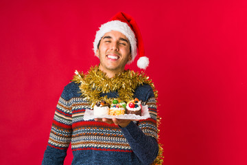 Young man holding a gift on christmas day