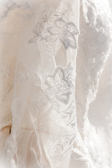 Details of the bride dress fabric and beautiful embroidery wedding concept used as a background for illustrations