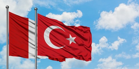 Peru and Turkey flag waving in the wind against white cloudy blue sky together. Diplomacy concept,...