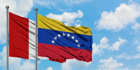 Peru and Venezuela flag waving in the wind against white cloudy blue sky together. Diplomacy concept, international relations.