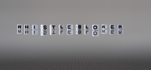 The concept of whistleblower represented by black and white letter cubes