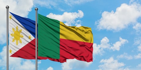 Philippines and Benin flag waving in the wind against white cloudy blue sky together. Diplomacy concept, international relations.