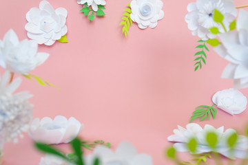 Obraz na płótnie Canvas White paper flowers on pink background. Floral