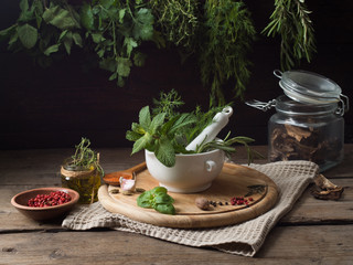Fresh spices thyme, turmeric, cardamom, basil, mint, parsley, dill  and rosemary on wooden background.