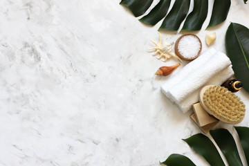 Spa massage products with monstera leaves on marble background © Инесса Шустикова