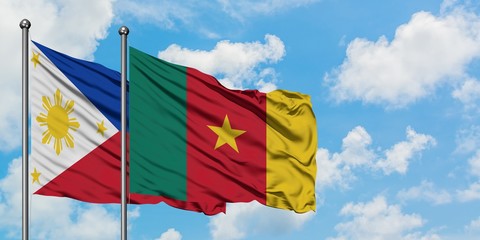 Philippines and Cameroon flag waving in the wind against white cloudy blue sky together. Diplomacy concept, international relations.