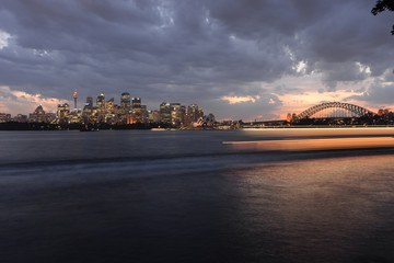 Ferry light trails with Sydney skyline and bridge at night