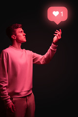 Man holding instagram like icon in hand on black background - 301149248