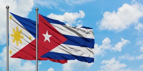 Philippines and Cuba flag waving in the wind against white cloudy blue sky together. Diplomacy concept, international relations.