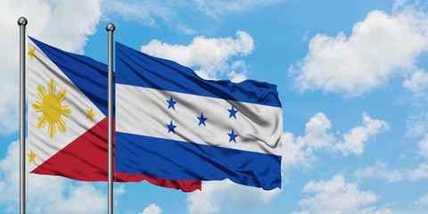 Philippines and Honduras flag waving in the wind against white cloudy blue sky together. Diplomacy concept, international relations.